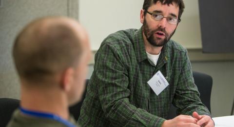 Two participants talk at the School of Marine Science and Ocean Engineering Graduate Research Symposium.