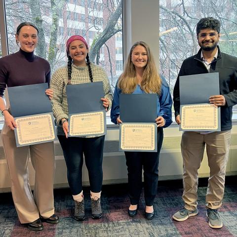 Color image of the four 2024 presentation winners holding their awards.