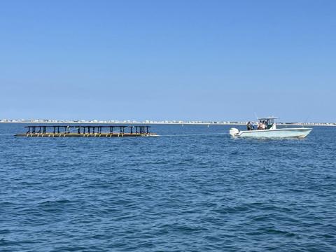 AquaFort being towed to farm site.