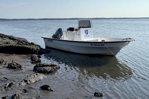 The small boat, Red Cloud, out on the water. 